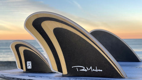 Rob Machado wood quad fins on beach.